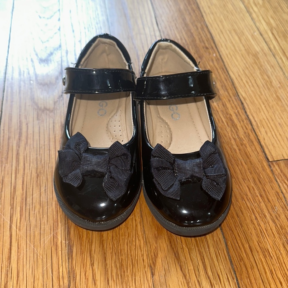 Black patten leather shoes.